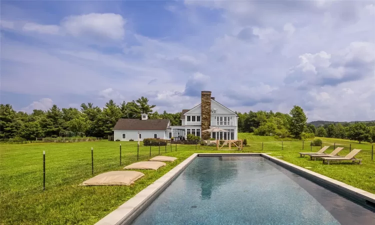 View of pool with a rural view and a yard