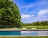 View of pool featuring a lawn