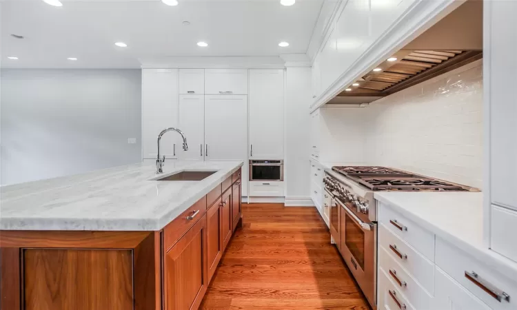 Custom kitchen with Thermador appliances and large island with marble countertops