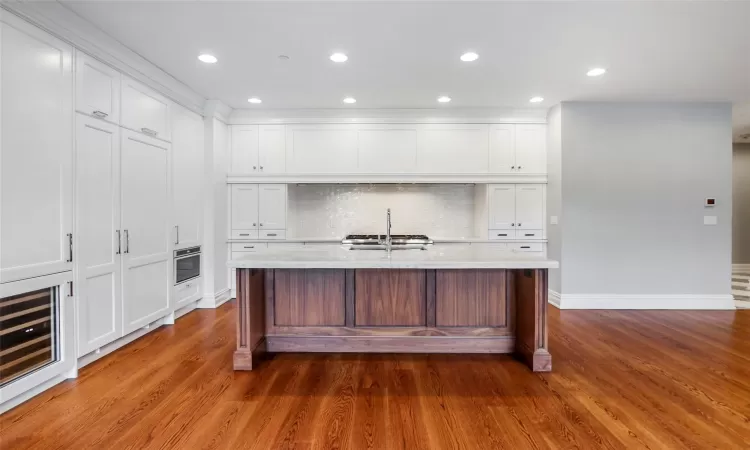 Custom kitchen with Thermador appliances and large island with marble countertops