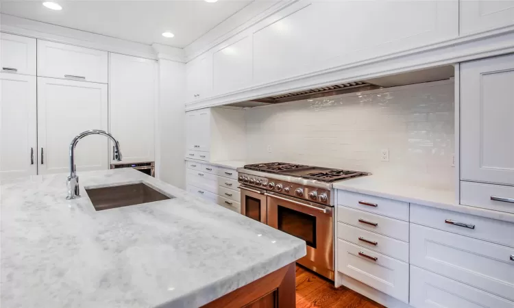 Custom kitchen with Thermador appliances and large island with marble countertops