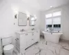 En-suite bath in 2nd bedroom with double vanity and free standing tub