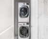 Laundry room featuring stacked washer and clothes dryer