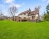 Back of house featuring a yard and a wooden deck