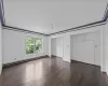 Unfurnished bedroom with dark hardwood / wood-style floors, ornamental molding, and a baseboard radiator