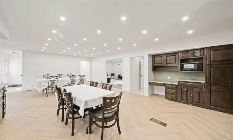 Dining area with light parquet floors