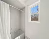 Bathroom with shower / tub combo with curtain