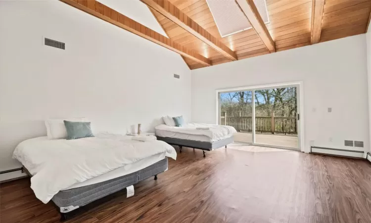 Bedroom with high vaulted ceiling, dark hardwood / wood-style flooring, wooden ceiling, and access to outside