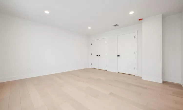 Bedroom with light hardwood flooring