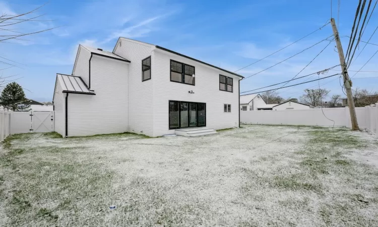 Rear view of house with a yard