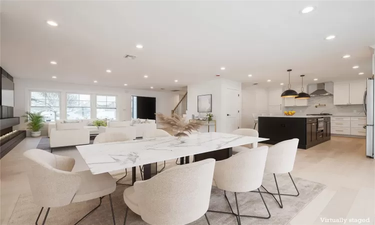 Virtually Staged Dining area featuring light hardwood flooring