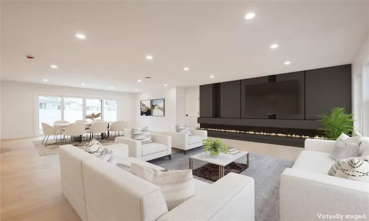 Virtually Staged Living room with light hardwood flooring