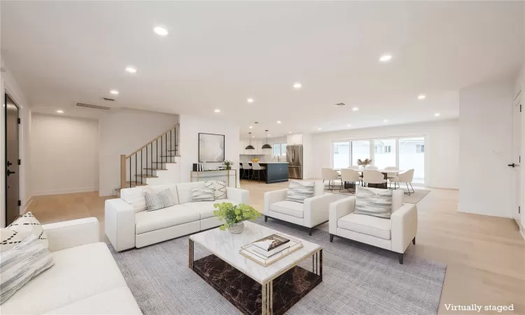 Virtually Staged Living room with light hardwood floors