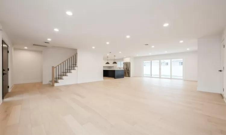 Unfurnished living room with light hardwood floors