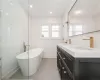 Primary Bathroom featuring a bathing tub, tile patterned flooring, and a healthy amount of sunlight