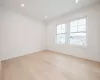 Bedroom with light hardwood flooring