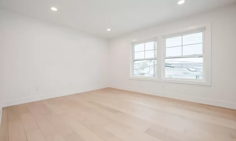 Bedroom with light hardwood flooring