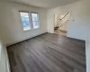 Unfurnished room with hardwood / wood-style floors and a baseboard radiator