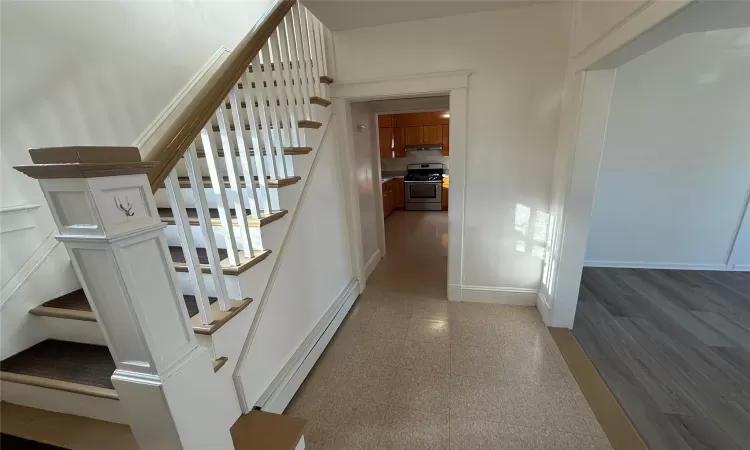 Stairway featuring a baseboard radiator