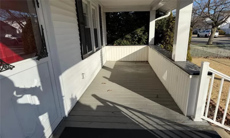 Wooden deck featuring covered porch