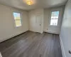 Unfurnished room with wood-type flooring and a baseboard heating unit