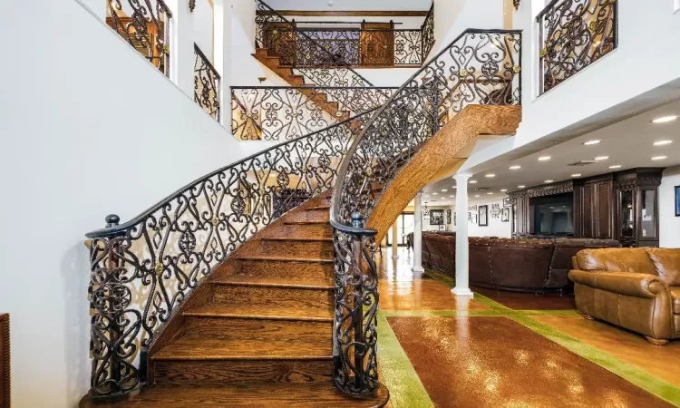 Stairs with ornate columns and a high ceiling