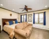 Bedroom with a baseboard heating unit, ceiling fan, crown molding, and dark hardwood / wood-style floors