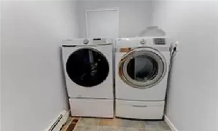 Washroom with washing machine and clothes dryer