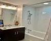 Bathroom featuring vanity and shower / bath combination with curtain