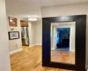 Hallway with light hardwood / wood-style flooring