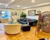 Living room with hardwood / wood-style flooring and ornamental molding