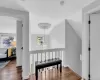 Hallway with dark wood-type flooring and lofted ceiling