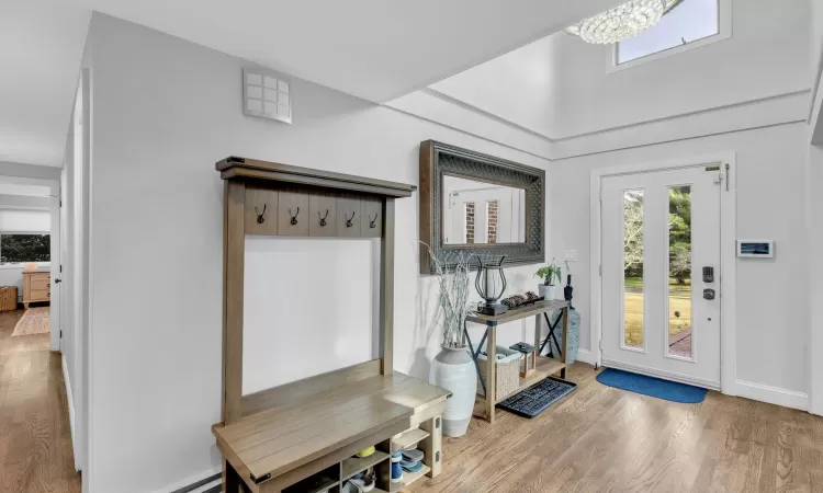 Entrance foyer with a chandelier and hardwood / wood-style floors