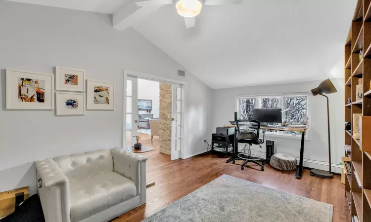 Office area featuring beam ceiling, ceiling fan, hardwood / wood-style floors, and high vaulted ceiling