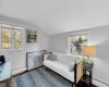 Living area featuring baseboard heating, a wealth of natural light, and lofted ceiling