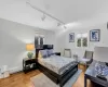 Bedroom featuring rail lighting and wood-type flooring