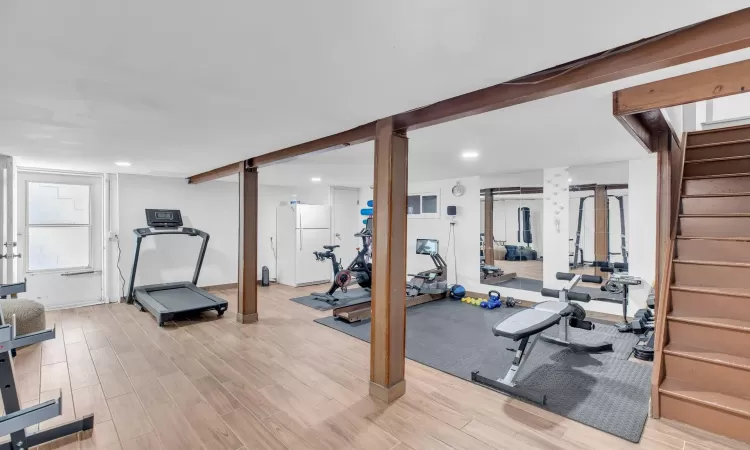 Workout room with light wood-type flooring