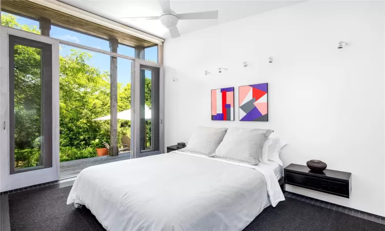 Bedroom featuring ceiling fan and multiple windows