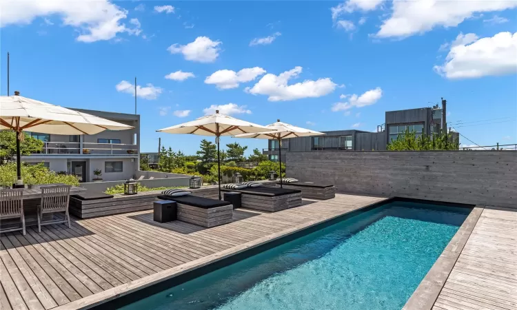 View of pool featuring a hot tub and a deck