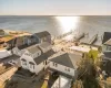 Aerial view at dusk featuring a water view