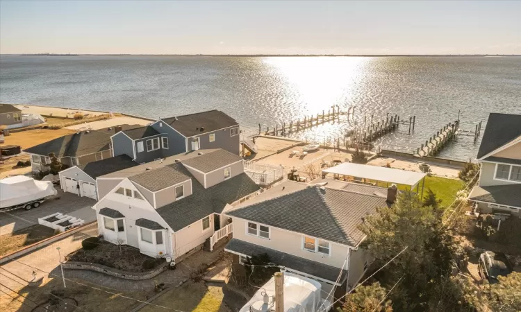 Aerial view at dusk featuring a water view