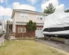 Rear view of house with a lawn and a garage