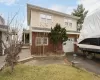 Back of property with a yard and a garage