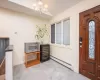 Entrance foyer featuring baseboard heating, a chandelier, and vaulted ceiling