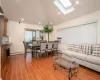 Living room featuring cooling unit, wood-type flooring, and a baseboard radiator