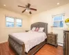 Bedroom with baseboard heating, ceiling fan, and crown molding