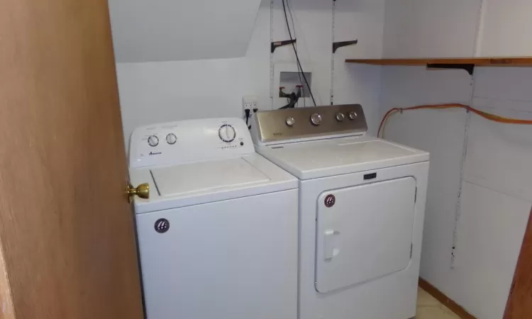 Washroom with washer and clothes dryer