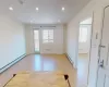 Unfurnished room with light hardwood / wood-style flooring and a baseboard heating unit