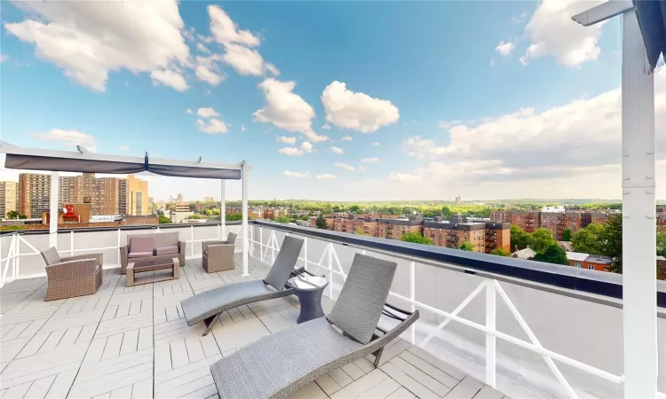 View of patio with outdoor lounge area and a balcony