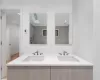 Bathroom with a skylight, a shower, and vanity